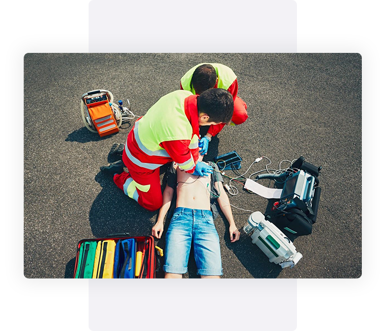 A man is laying on the ground with an adult