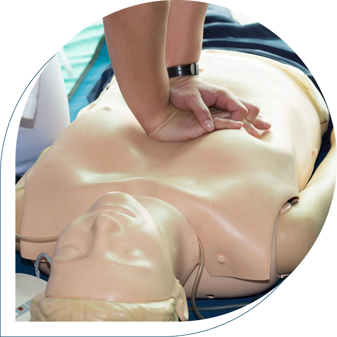 A person is performing cpr on an infant dummy.