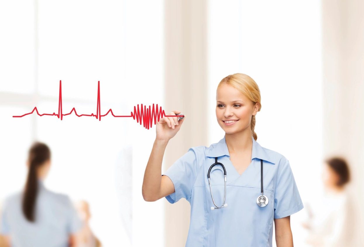 A nurse is drawing an ekg on the wall.